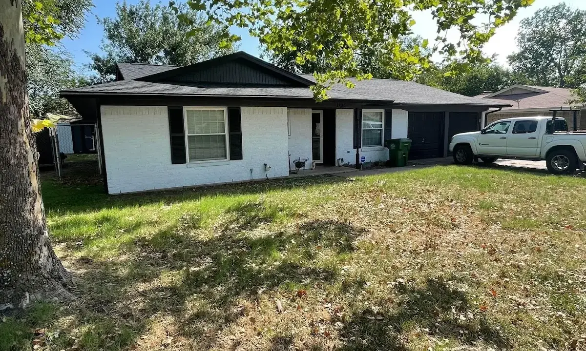 Professional roofing crew working on a residential roof in Hewitt